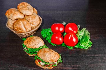 sandwich - hamburger with burger, cheese, tomato, and onion on wooden background