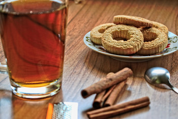 A cup of tea and cookies on a wooden table