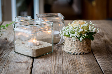 DIY Wedding decoration with candles, sand and flowers