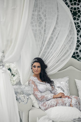 Fototapeta premium The charming bride sits on the luxury sofa