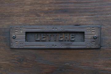 mailbox in wooden door in Italy, the city of Brescia