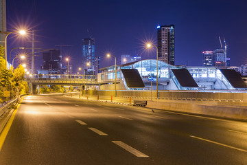 Fototapeta na wymiar Empty freeway at night And Tel Aviv Cityscape in Background