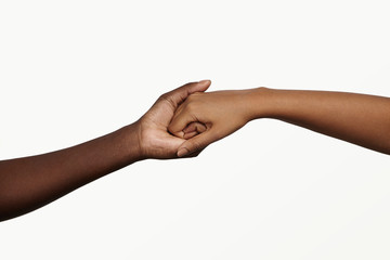 Two African people holding their hands tight together. Friendship, love, trust and support concept...