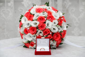 Wedding rings and roses bouquet