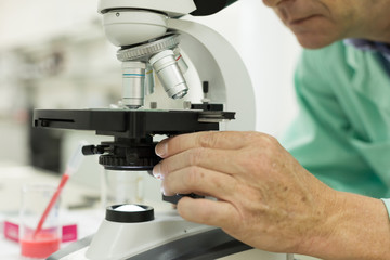 Scientific researcher in the laboratory with a microscope