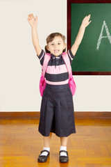 Happy Little School Girl at school classroom