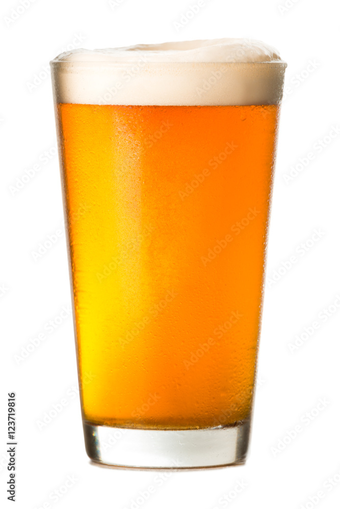 Wall mural Pint glass of amber ale lager beer with golden light and foamy head isolated on white background