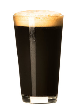PInt of dark stout beer with thick foam head isolated on white background