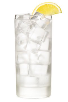 Vodka tonic soda ice water in tall highball glass with lemon wedge garnish isolated on white background