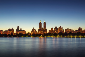 Upper West Side buildings and Central Park Jacqueline Kennedy Onassis Reservoir at twilight....