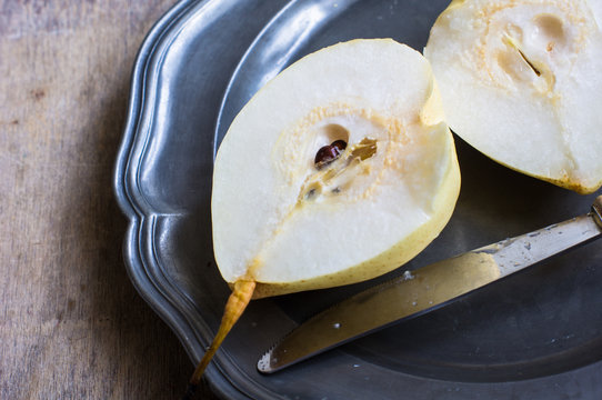 Ripe pear on vintage plate