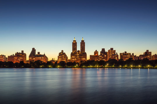 Upper West Side buildings and Central Park Jacqueline Kennedy Onassis Reservoir at twilight. Manhattan, New York City