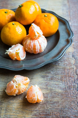 Ripe tangerines on vintage plate