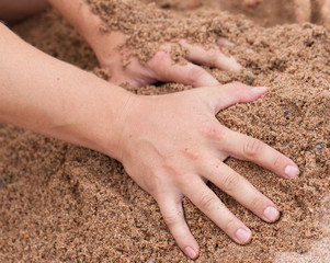 Hands in the sand on the beach