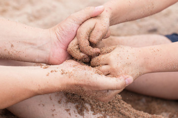 Hands in the sand on the beach