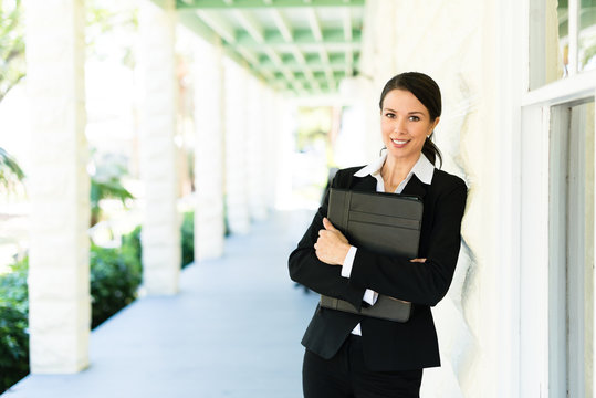 Attractive Female Woman Real Estate Agent Businesswoman On House Veranda