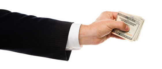 Businessman's arm and hand extending a thick wad of American U.S. Twenty Dollar Bills in a bribe or tip or gift isolated on white background