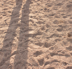 shadows of feet in the sand