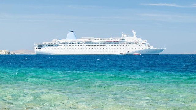 Generic Cruise Ship Close-up in the Greek Islands Anchored Off Mykonos with Vibrant Blue Mediterranean Aegean Sea Water