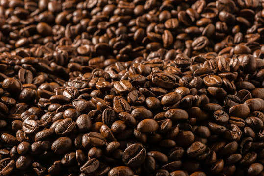 Sea of dark roasted coffee beans filling frame