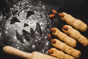  Halloween witch finger cookies for kids, funny recipe for Halloween party. Homemade cookies in the form of terrible human fingers decoration almond nail for treat kids for Halloween party © zinaidasopina112