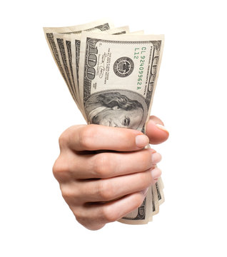 Woman's hand holding grasping gripping several hundred dollar bills isolated on white background