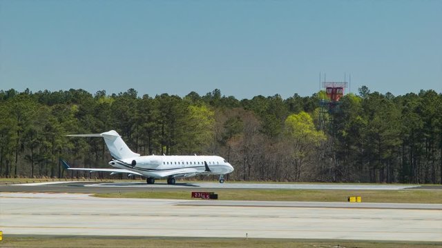 Generic Business Jet Taxiing Onto Runway at Raleigh-Durham International Airport on a Sunny Day in North Carolina