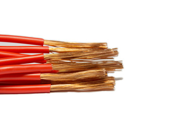 Flexible cooper wire with red insulation isolated on a white background with space for text.