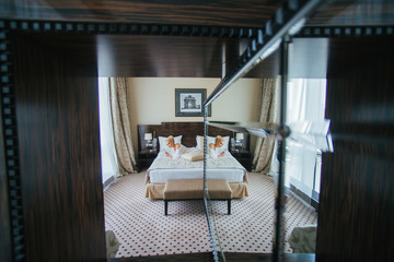 A look from afar on a stunning lady lying on the bed and reflect