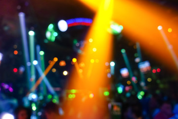 Defocused glowing background with abstract bokeh of laser show in modern disco night club