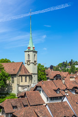 Obraz premium Bern cityscape. Swiss capital city. Nydeggkirche (Nydegg Church) and tiled rooftops