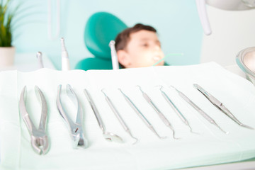 Obraz premium Little cute kid smiling while sitting in chair at dental clinic