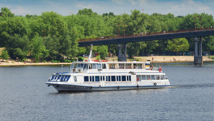 Obraz premium White cruise boat on the river.