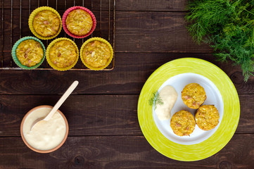 Muffins from cabbage with ham and cheese. Sour cream sauce.  The top view