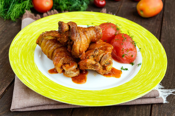 Chicken legs with tomato sauce and marinated tomatoes without skins in their own juice.