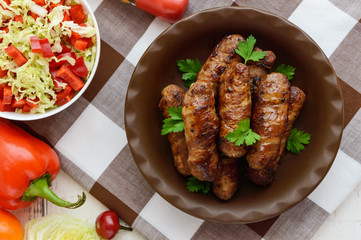 Juicy grilled rolls of minced meat wrapped in bacon. The top view