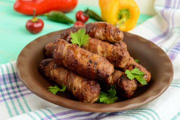 Juicy grilled rolls of minced meat wrapped in bacon.