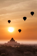 Old bagan in morning mist and silhouette of hot air balloon, tou