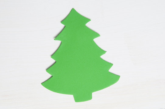 green foan christmas tree on a white wooden background