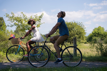Fototapeta premium Young multiethnic couple having a bike ride in nature