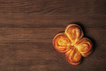 Yellow cookie on a dark wooden background