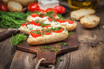 Delicious bruschetta with tomatoes, feta cheese, dill and spice