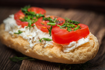 Delicious bruschetta with tomatoes, feta cheese, dill and spice