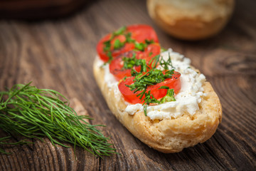 Delicious bruschetta with tomatoes, feta cheese, dill and spice