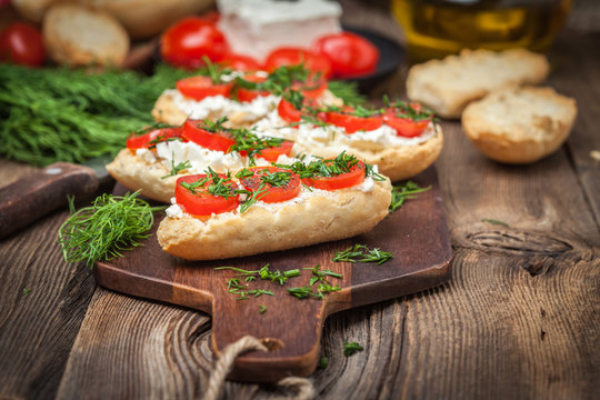 Delicious bruschetta with tomatoes, feta cheese, dill and spice
