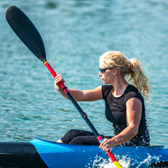 Action portrait of a female kayak champion © Microgen