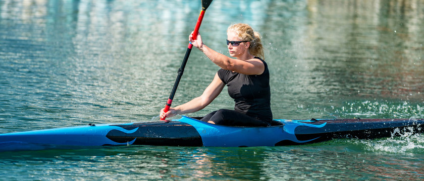 Sport kayak. Female kayaking champion paddling
