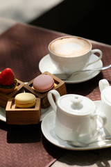 Cup of cappuccino and macaroons