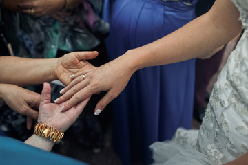 Bride is showing a wedding ring to the guests