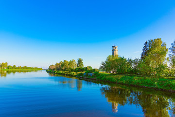 Fototapeta na wymiar old lighthouse on the river